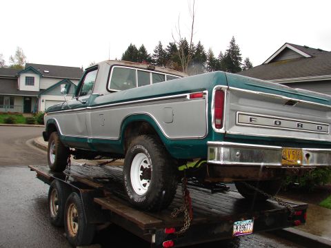 1996 Ford Bronco - This Ford F-Series truck, with its distinctive body style, is being transported on a trailer.