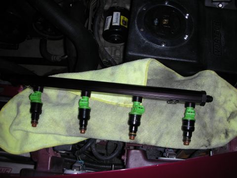 1992 Ford Crown Victoria - Close-up of a fuel rail assembly with injectors, part of an engine bay.