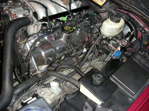 1992 Ford Crown Victoria - Close-up view of an engine bay, showing chrome valve covers and various engine components.