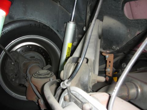 1992 Ford Crown Victoria - The rear suspension and wheel assembly of a vehicle are shown in detail, including the shock absorber and brake system.