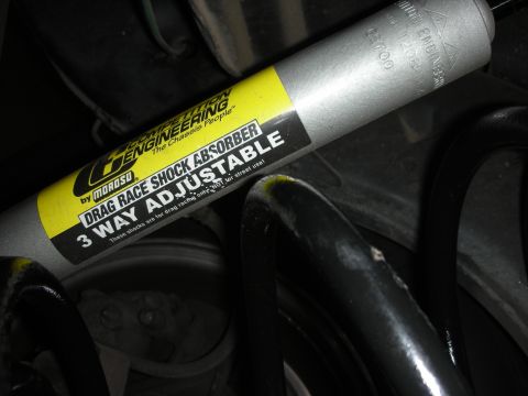 1992 Ford Crown Victoria - Close-up of a "Competition Engineering" drag race shock absorber, indicating it is not for street use.