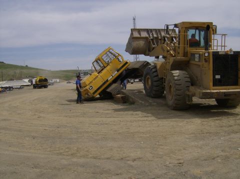1986 Ford Bronco - Construction equipment is shown in a yard with a blue sky overhead.
