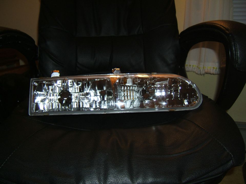 headlight assembly resting on a black leather chair