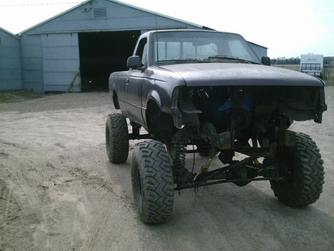 2001 Dodge 2500 - Pickup truck with significant modifications, including a lift kit and removed front end.