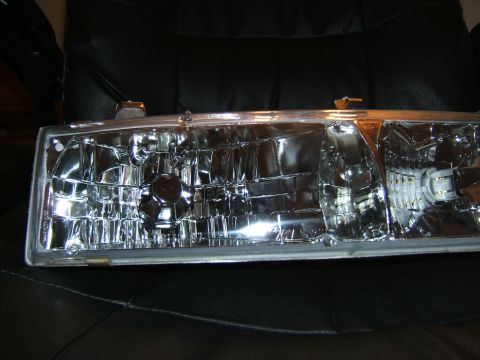 1998 Ford Taurus - A single headlight assembly is shown, with visible internal reflectors and bulb sockets.