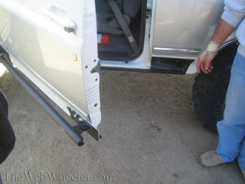 1996 Ford Bronco - Open side door of a 1996 Ford Bronco reveals interior details and a fire extinguisher.