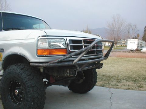 1996 Ford Bronco - A silver Ford F-Series truck is shown from the front with a custom bumper and off-road tires.