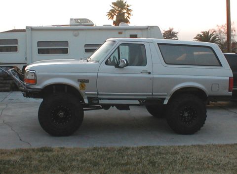1996 Ford Bronco - Silver 1996 Ford Bronco modified for off-road use, parked outdoors.