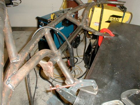 1996 Ford Bronco - Metal frame components are being welded together, with welding machines visible in the background.