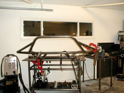 1996 Ford Bronco - Custom roll cage fabrication in progress, showing tubing, welding gear, and tools.