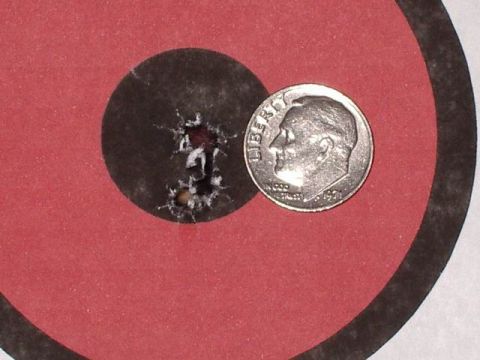 1985 Ford Bronco - Bullet holes on a target are shown next to a dime for size comparison.