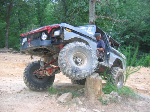 1992 Ford Mustang - This heavily modified Ford Bronco is navigating an obstacle on an off-road trail.