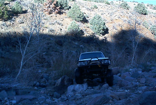 1986 Ford Bronco front view with bull bar on rocky terrain