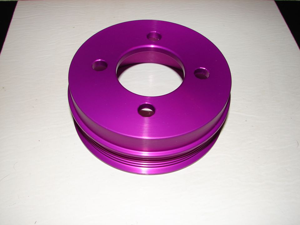 Purple aluminum pulley with three bolt holes and a central opening