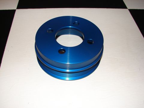 1992 Ford Taurus - A blue aluminum pulley with a grooved circumference is shown against a black and white checkered background.