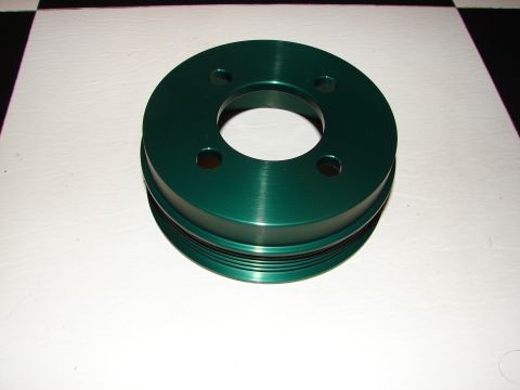 1992 Ford Taurus - A green pulley with a ribbed outer edge is shown against a checkered and white background.