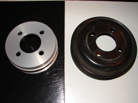 1992 Ford Taurus - Comparison of a new silver pulley next to an older black pulley.