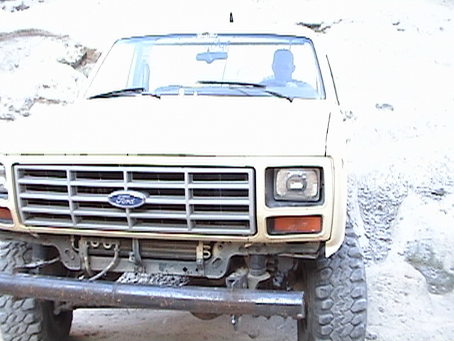 Front view of a tan 1980s Ford pickup truck