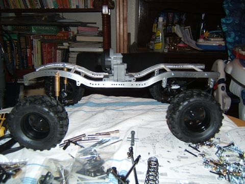 1988 Ford Bronco - An RC crawler chassis is assembled on a table with various parts and instructions visible.