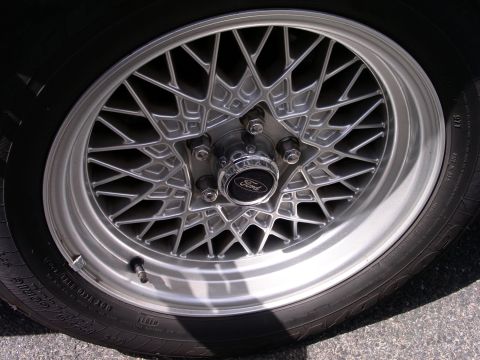 2001 Ford Crown Victoria - This is a close-up of a silver mesh-spoke wheel with a Ford logo center cap.