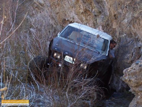 1986 Ford Bronco - This 1986 Ford Bronco is seen off-roading through a challenging rocky terrain, with a person inside the vehicle.