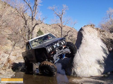1986 Ford Bronco - This heavily modified SUV navigates a challenging off-road course, demonstrating its off-road capabilities.