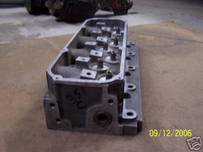 1972 Ford Ranchero - A close-up view of an engine cylinder head, with handwritten markings '53 MU' visible on its side.
