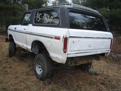 1979 Ford Bronco - Rear view of a white 1978 Ford Bronco with a black hardtop, parked outdoors. Price is marked on the window.