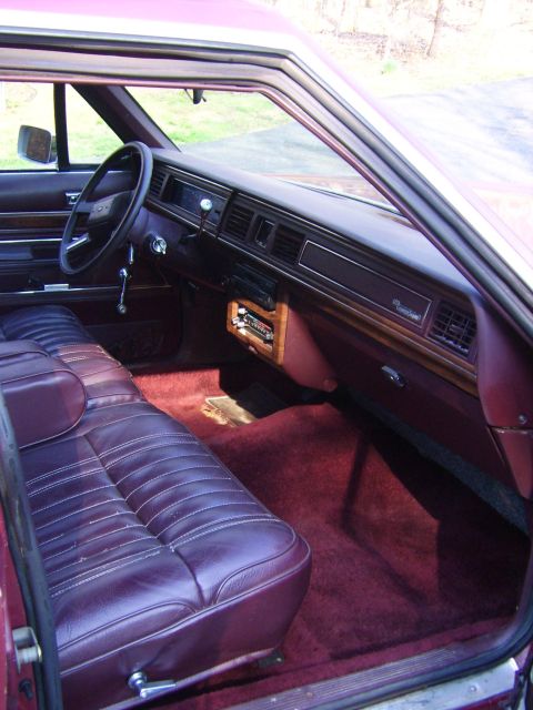 1982 Ford LTD Crown Victoria - Interior view of a 1982 Ford Crown Victoria LTD, plush maroon carpeting and a classic dashboard design.
