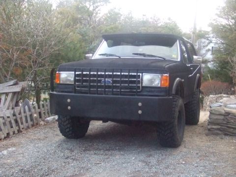 1995 Ford Mustang - This black Ford Bronco II is equipped with a heavy-duty aftermarket bumper and a distinctive grille. It sits on lifted suspension with tire…