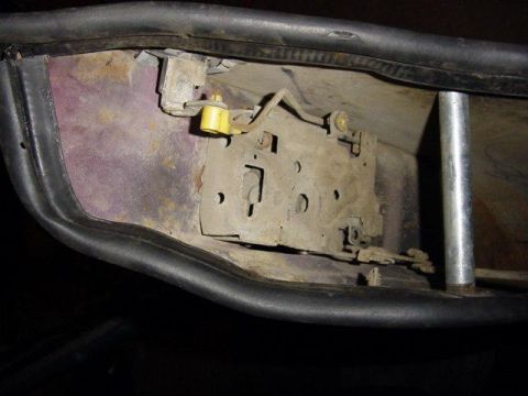 1992 Ford Bronco - Door latch mechanism detail, showing internal components and some corrosion.