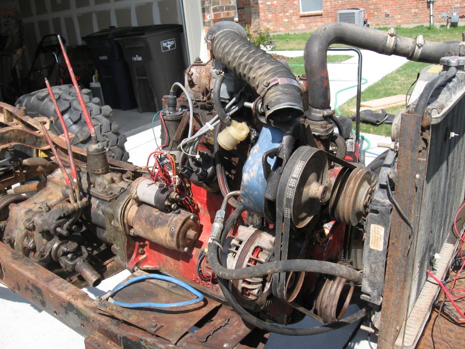 Rusty vehicle frame with engine, transmission, and radiator assembly