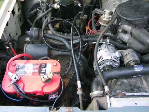 1991 Ford Bronco - Close-up view of a vehicle's engine bay, showing the battery and alternator.