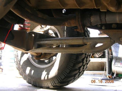 1992 Ford Explorer - The underside of a vehicle is visible, focusing on suspension and tire details with red markings on a bracket.