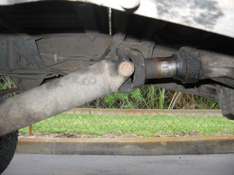 1974 Ford F-100 - Underside view of a vehicle's driveshaft and U-joint, showing mechanical components.