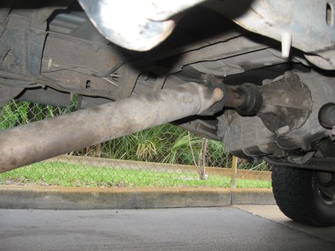 1974 Ford F-100 - Close-up view of the drivetrain components underneath a vehicle.