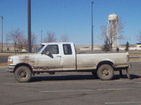 1992 Ford F-250 - This 1992 Ford F-250 pickup truck is seen from the side, heavily coated in mud.