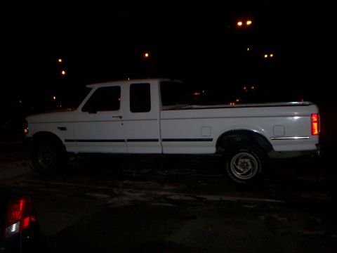 1992 Ford F-250 - Side view of a white 1992 Ford F-250 crew cab pickup truck at night.