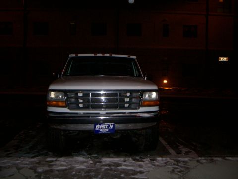 1992 Ford F-250 - A white Ford F-250 is parked outside at night, with snow on the ground.