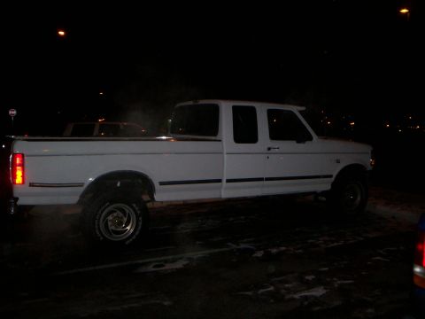 1992 Ford F-250 - A white 1992 Ford F-250 pickup truck is seen from the side at night.