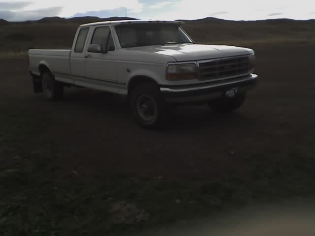 White 1992 Ford F-250 pickup truck parked outside