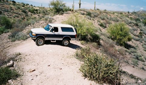 1996 Ford Bronco - This 1996 Ford Bronco navigates a dusty trail through a desert environment.
