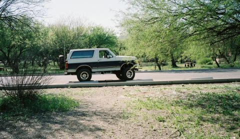 1996 Ford Bronco - This two-tone 1996 Ford Bronco is seen parked curbside with a spare tire mounted on the rear.