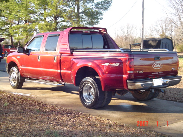 Red Ford F-350 crew-cab dually pickup, rear three-quarter view