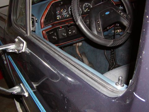1988 Ford Bronco - Interior view of a 1987 Ford Bronco, focusing on the dashboard and driver's side door frame.
