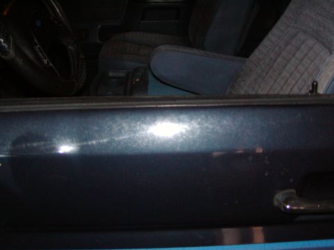 1988 Ford Bronco - Interior view of a 1988 Ford Bronco, showing the door panel and fabric seats.