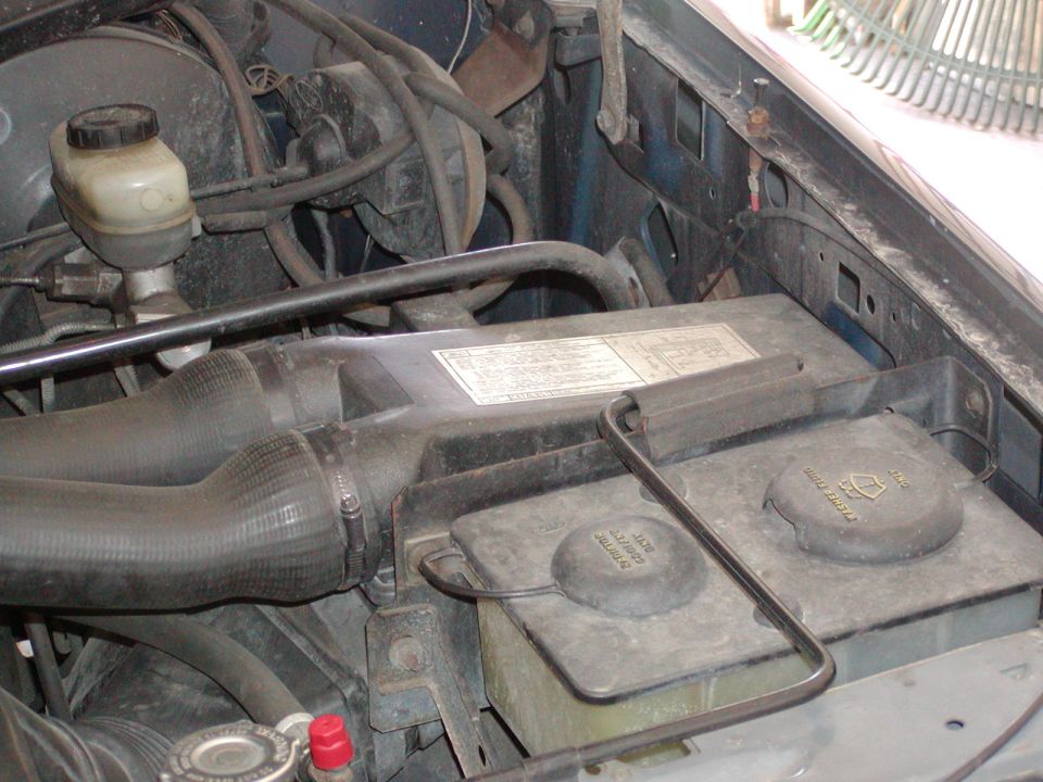Engine bay corner with brake master cylinder, battery and air intake duct