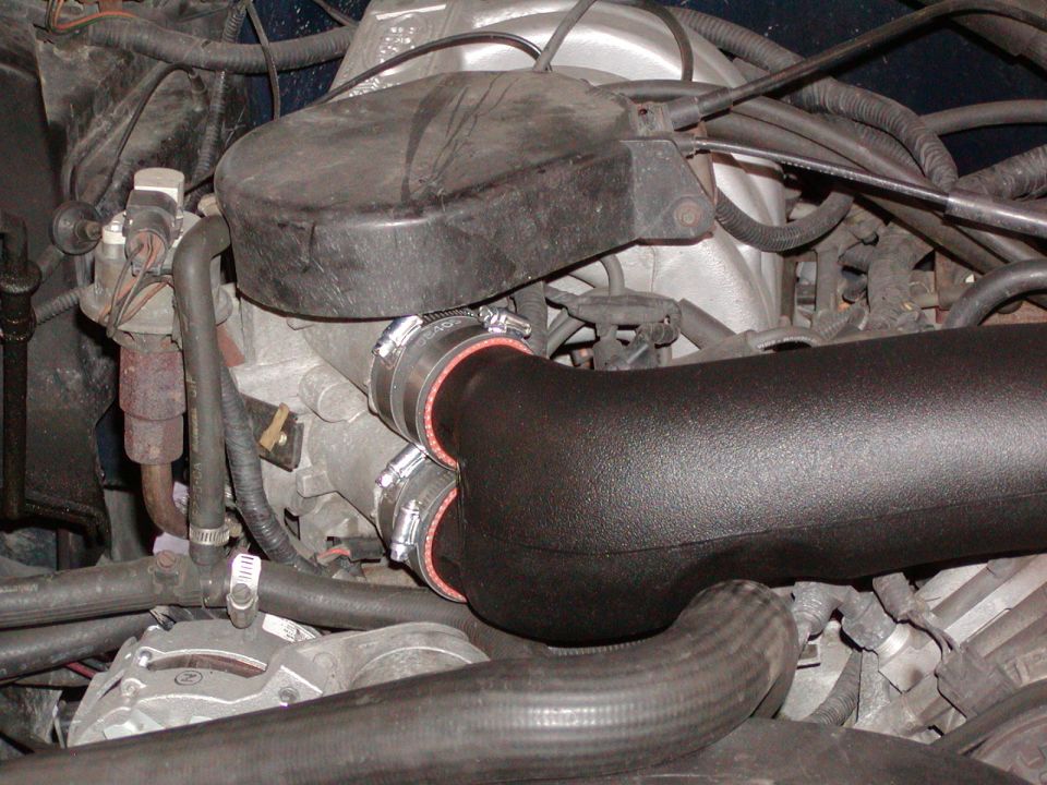 Engine with black aftermarket intake tube and silicone couplers
