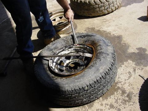1992 Ford Bronco - tires must go off and on the rim from the front!!! Two tire bars required. Do one first and start to bring the lip over the rim edge while…