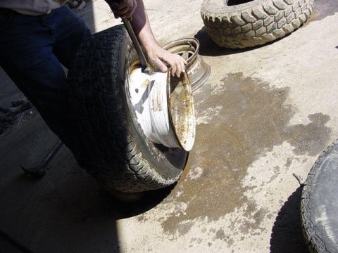 1992 Ford Bronco - now that the first bead is off the rim, flip it up and hold it like shown and insert tire bar and work it off the rim like you did the firs…